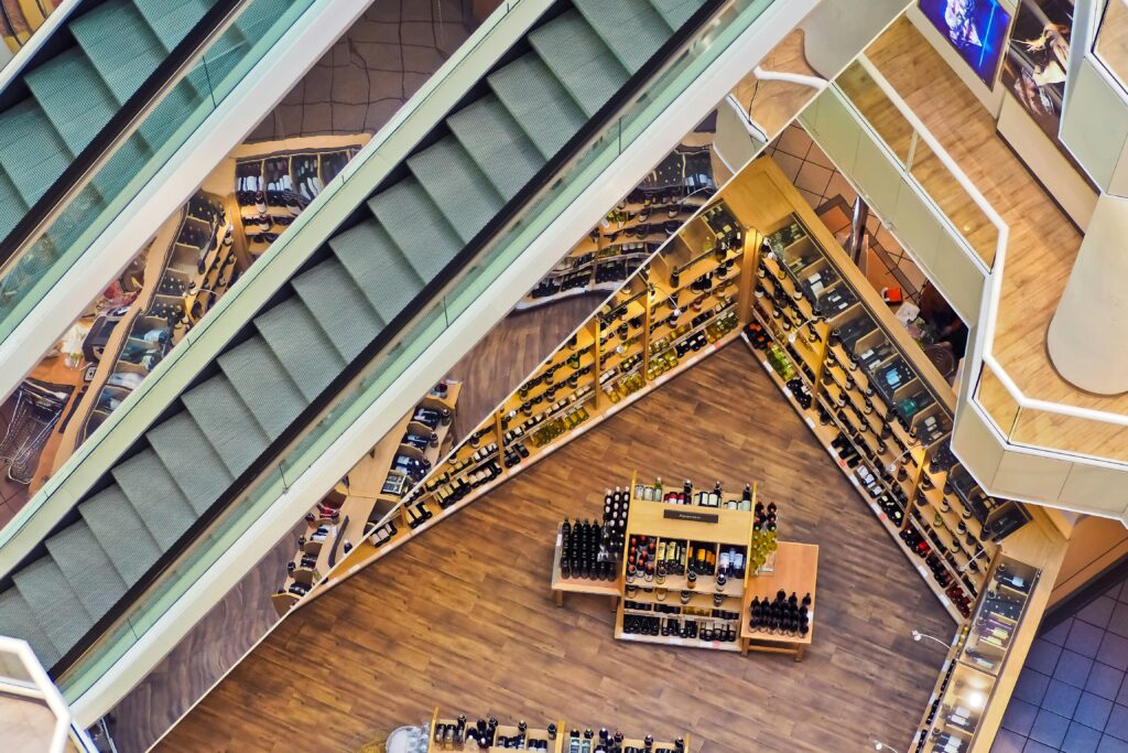 Aerial view of a stylish shopping mall showcasing escalators and well-organized retail displays.