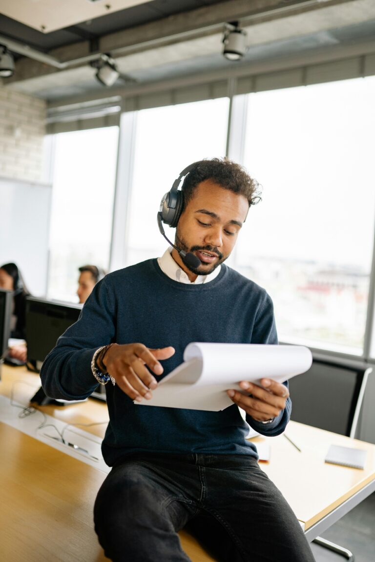 Focused man working in modern call center office with headset.